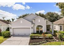 Charming single-story home with well-manicured landscaping and a two-car garage at 10166 Hidden Dunes Ln, Orlando, FL 32832