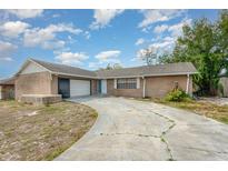 Charming single-story brick home with attached garage and curved driveway at 1030 Blue Horizon Dr, Deltona, FL 32725