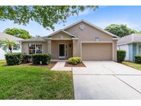 Charming single-story home with a well-manicured lawn and a two car garage at 3661 Kingswood Ct, Clermont, FL 34711