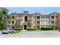 Inviting multi-story condo building with private balconies and well-maintained landscaping at 411 Terrace Ridge Cir # 222, Davenport, FL 33896