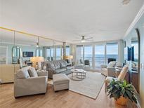 Bright living room with comfortable seating and balcony access offering beautiful ocean views at 4601 S Atlantic Ave # 7030, Port Orange, FL 32127