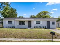 Charming single-story home with well-maintained landscaping and a fresh exterior paint job on a sunny day at 507 Peach Tree Ln, Altamonte Springs, FL 32701