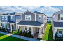 Beautiful two-story home featuring a covered front porch, neutral colors, and well-maintained landscaping at 635 Cheval Ln, Debary, FL 32713