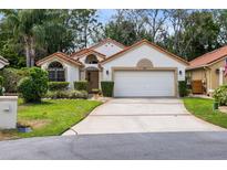 Charming single-story home with a two-car garage, well-maintained landscaping, and a welcoming facade at 912 Augusta National Blvd, Winter Springs, FL 32708