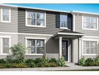 Charming two-story home with gray siding, blue shutters, and manicured landscaping at 9972 Red Canoe Aly, Orlando, FL 32832