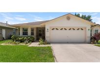 Charming single-story home with a well-manicured lawn and attached two-car garage at 2244 Silver Lakes N Dr, Lakeland, FL 33810
