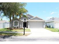 Charming single Gathering home featuring a two-car garage and mature landscaping at 2407 Oakington St, Winter Garden, FL 34787