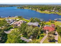 Aerial shot of estate home showcasing lake access and mature landscaping at 2828 Marquesas Ct, Windermere, FL 34786