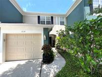 Charming two-story home with a one-car garage and welcoming walkway surrounded by lush landscaping at 5114 Hawkstone Dr, Sanford, FL 32771