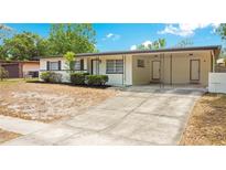 Charming single story home featuring updated black shutters, a large driveway, and covered porch at 6820 Ambassador Dr, Orlando, FL 32818