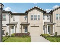 Charming townhome showcasing a well-manicured lawn and an attached single-car garage at 734 Longboat Dr, Davenport, FL 33896