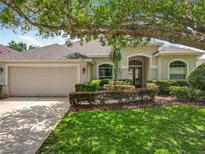 Charming single-story home with a well-manicured lawn and beautiful landscaping, showcasing its curb appeal at 903 Kersfield Cir, Lake Mary, FL 32746
