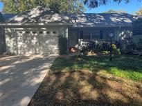 Charming single-story home with a well-manicured front yard and attached two-car garage at 9490 Sw 85Th Ave # E, Ocala, FL 34481