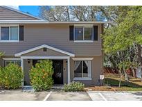 Charming two-story townhome featuring a neutral color, black shutters, and well-maintained landscaping at 130 Kristi Ann Ct, Winter Springs, FL 32708