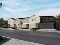Charming new construction townhomes showcasing a two-story design, private garages, and craftsman-style details at 16458 Bird Of Paradise Ave, Clermont, FL 34714
