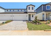Charming two-story home featuring a paved driveway, attached garage, and landscaped front yard at 1812 Archer Dr, Minneola, FL 34715