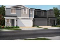 Charming two-story townhomes showcasing appealing architectural details and well-manicured landscaping in a residential neighborhood at 1816 Archer Dr, Minneola, FL 34715