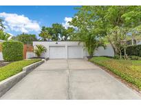 Detached two-car garage with a concrete driveway and beautifully landscaped yard at 1845 Delaney Ave, Orlando, FL 32806