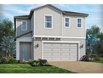 Charming two-story home with a two-car garage, beautiful landscaping, and a welcoming front entrance at 1888 Archer Dr, Minneola, FL 34715