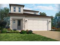 Charming two-story home featuring a neutral color scheme, brick accents, an attached garage, and a well-manicured front lawn at 1904 Archer Dr, Minneola, FL 34715