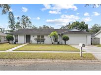 Charming single-story home featuring a well-maintained lawn, two-car garage, and inviting curb appeal at 2028 Sussex Rd, Winter Park, FL 32792