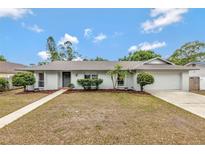 Charming single-story home featuring a well-manicured lawn and a driveway leading to an attached garage at 2028 Sussex Rd, Winter Park, FL 32792