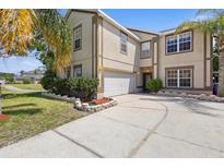 Charming two-story home featuring a two-car garage and well-maintained landscaping at 2260 The Oaks Blvd, Kissimmee, FL 34746
