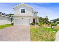 Charming two-story home featuring a spacious two-car garage and well-maintained front yard at 2680 Nottel Dr, St Cloud, FL 34772