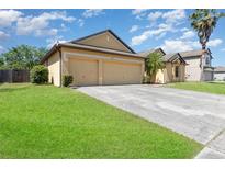 Charming single-Gathering home featuring an attached two-car garage and well-maintained lawn at 2739 Village Pine Ter, Orlando, FL 32833