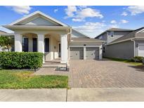Charming single-story home featuring a brick driveway and attached two-car garage at 5511 Orange Orchard Dr, Winter Garden, FL 34787