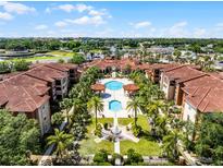 Beautiful aerial view of resort-style apartments and pools with lush landscaping and meticulous grounds at 5530 Metrowest Blvd # 309, Orlando, FL 32811