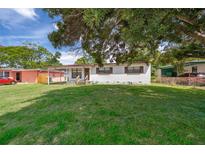 A charming single-story home featuring a well-maintained lawn and a classic exterior at 5601 Andora St, Orlando, FL 32807