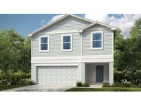 Charming two-story home featuring a modern exterior, garage, and professionally landscaped yard at 5657 Loggia Ln, Kissimmee, FL 34758