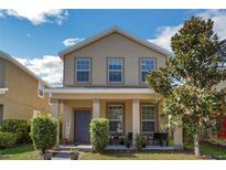 Charming two-story home featuring a welcoming front porch and well-maintained landscaping at 6822 Habitat Dr, Harmony, FL 34773