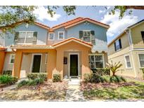 Charming townhome with a colorful exterior, manicured landscaping, and a welcoming front entrance at 7348 Yoder St, Windermere, FL 34786