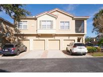 Well-maintained townhome with attached garages and neutral color scheme at 7505 Pellham Way, Kissimmee, FL 34747