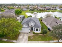 Charming home with well-maintained lawn and lovely water view, perfect for serene living at 10414 Andover Point Cir, Orlando, FL 32825