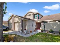 Inviting two-story home with a well-maintained lawn and a two car garage at 12133 Augusta Woods Cir, Orlando, FL 32824