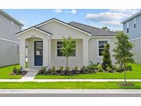 Charming single-story home with a well-maintained lawn and inviting blue front door at 13046 Pergola Ave, Orlando, FL 32832