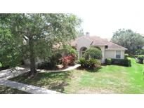 Well-manicured lawn and mature landscaping enhance this charming single-story home at 13250 Meergate Cir, Orlando, FL 32837