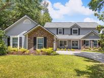Charming two-story home featuring a manicured lawn, brick accents, and a welcoming front entrance at 226 Ringwood Dr, Winter Springs, FL 32708