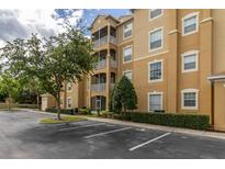 Well-maintained condo building featuring multiple screened patios, professional landscaping, and ample parking at 2785 Almaton Loop # 202, Kissimmee, FL 34747
