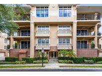 Elegant condo building featuring balconies and manicured landscaping at 918 Lotus Vista Dr # 102, Altamonte Springs, FL 32714
