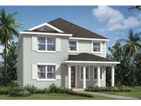 Charming two-story home featuring traditional architectural style and lush landscaping at 9560 Archway Aly, Orlando, FL 32832