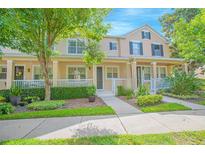 Charming townhome with a landscaped front yard and inviting porch at 9635 Fenrose Ter, Orlando, FL 32827
