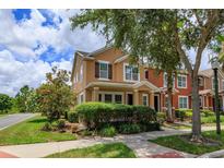 Charming two-story home featuring a manicured lawn and beautiful landscaping at 10128 Hartford Maroon Rd, Orlando, FL 32827