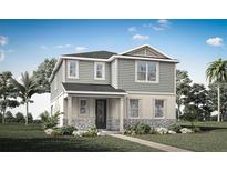 Charming two-story home featuring stone accents, gray siding, a well-manicured lawn, and a welcoming front porch at 13016 Pergola Ave, Orlando, FL 32832