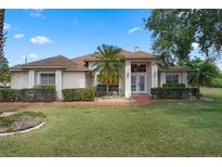 Charming home featuring a well-manicured lawn, mature landscaping, and a welcoming front entrance at 1441 Olde Kensington Ln, Deltona, FL 32725