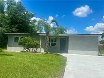 Charming single story home boasts lush green lawn, freshly painted exterior, and newly laid concrete driveway at 2514 Highlawn Ave, Sanford, FL 32773