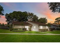 Charming single-story home featuring mature trees and a well-manicured lawn at 262 W Sabal Palm Pl, Longwood, FL 32779